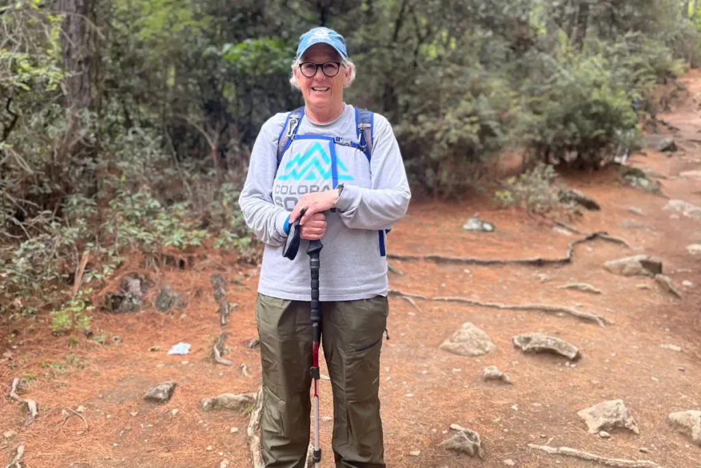Lee, elderly trekker from Colorado, USA hiking Tiger’s Nest monastery trail in Bhutan.