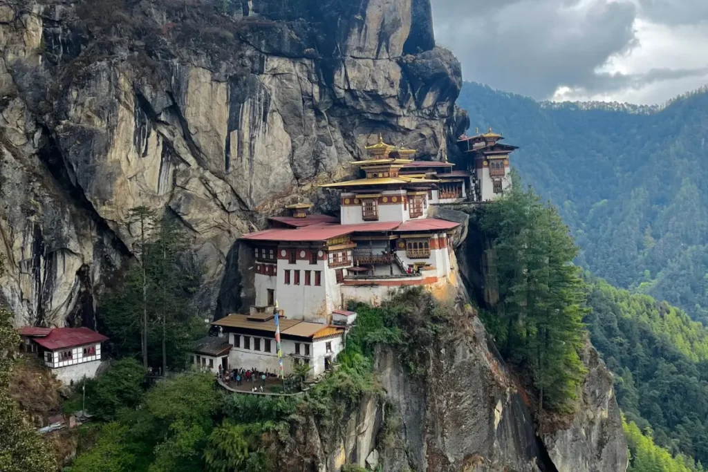 Tiger’s Nest Hike – capturing the majestic monastery perched on a cliffside, surrounded by Bhutan’s lush green forests and mountains.