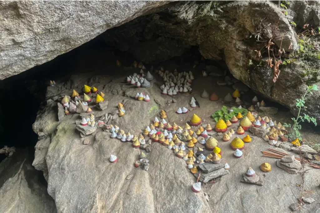 Tsa-tsas near a cave entrance on the trail to Tiger’s Nest Monastery in Bhutan, symbolizing Buddhist devotion and spiritual offerings.
