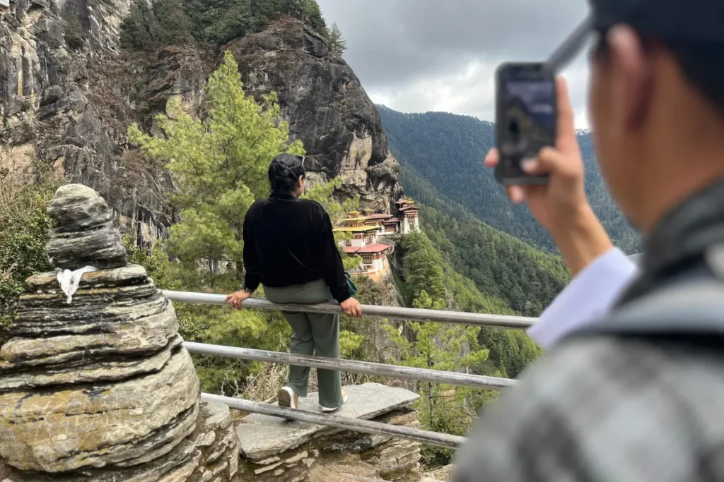 Tiger's Nest Hike- A traveler pauses to take in the stunning view of Tiger’s Nest Monastery, while a friend snaps a photo to capture the unforgettable moment
