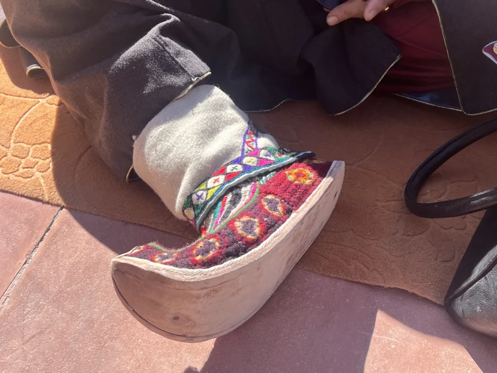 She wore traditional Ladakhi shoes with carved wooden soles and colorful wool uppers