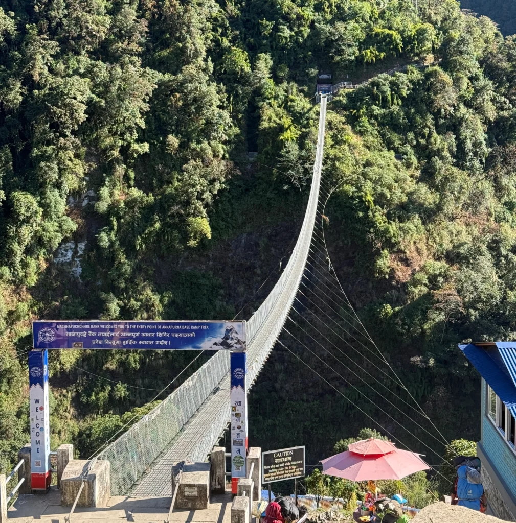 New Jhinu Danda suspension bridge (Kadoorie Bridge) over Modi Khola with lush green valley views, Annapurna Base Camp Trek, Nepal