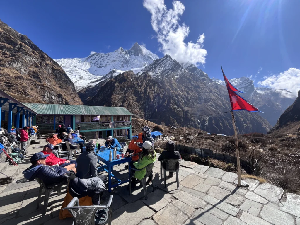 Trekkers enjoying lunch with a view of majestic Machapuchare